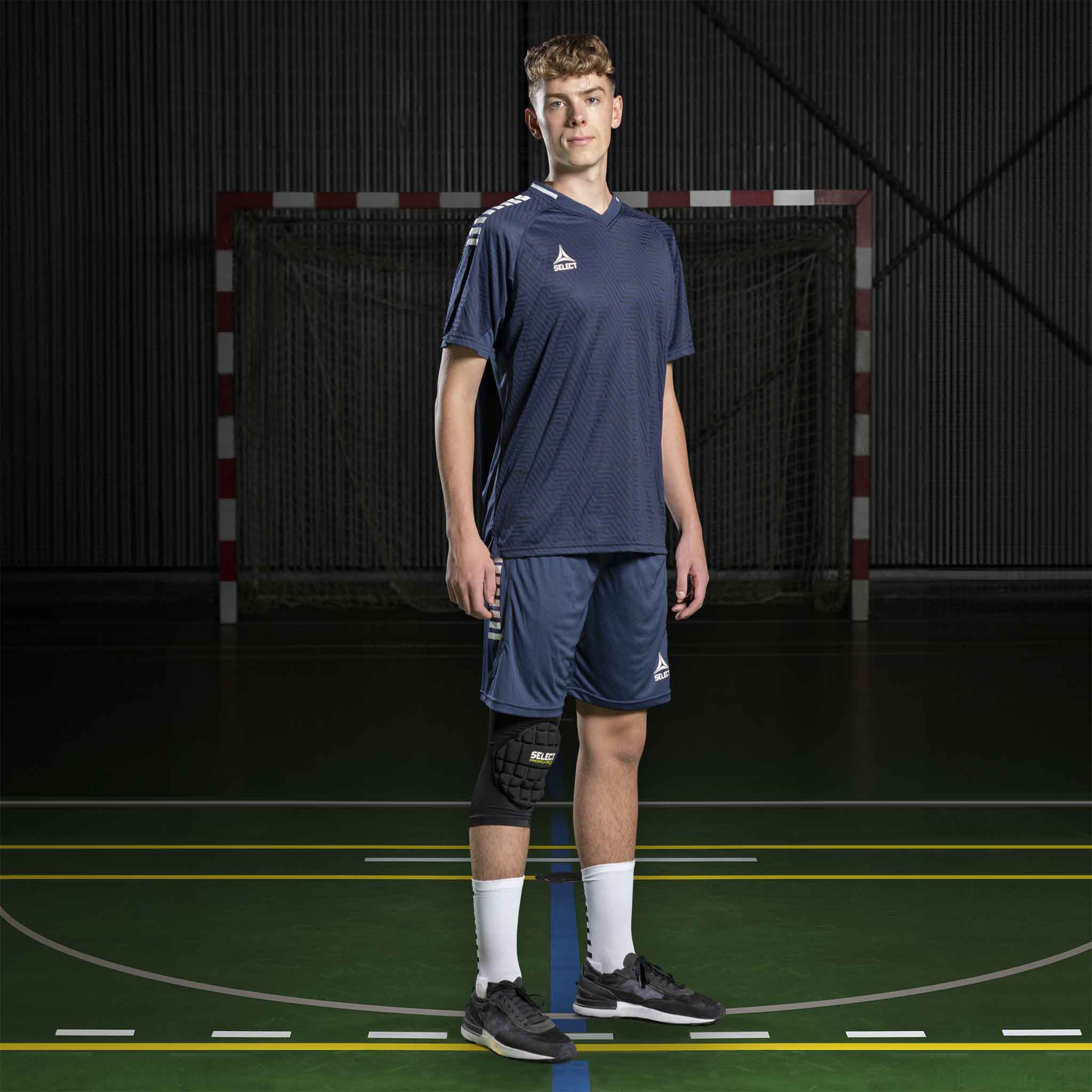 Mannlig håndballspiller i marineblå og hvit Player shirt S/S Monaco v24, Match & Training wear, sett forfra på banen.