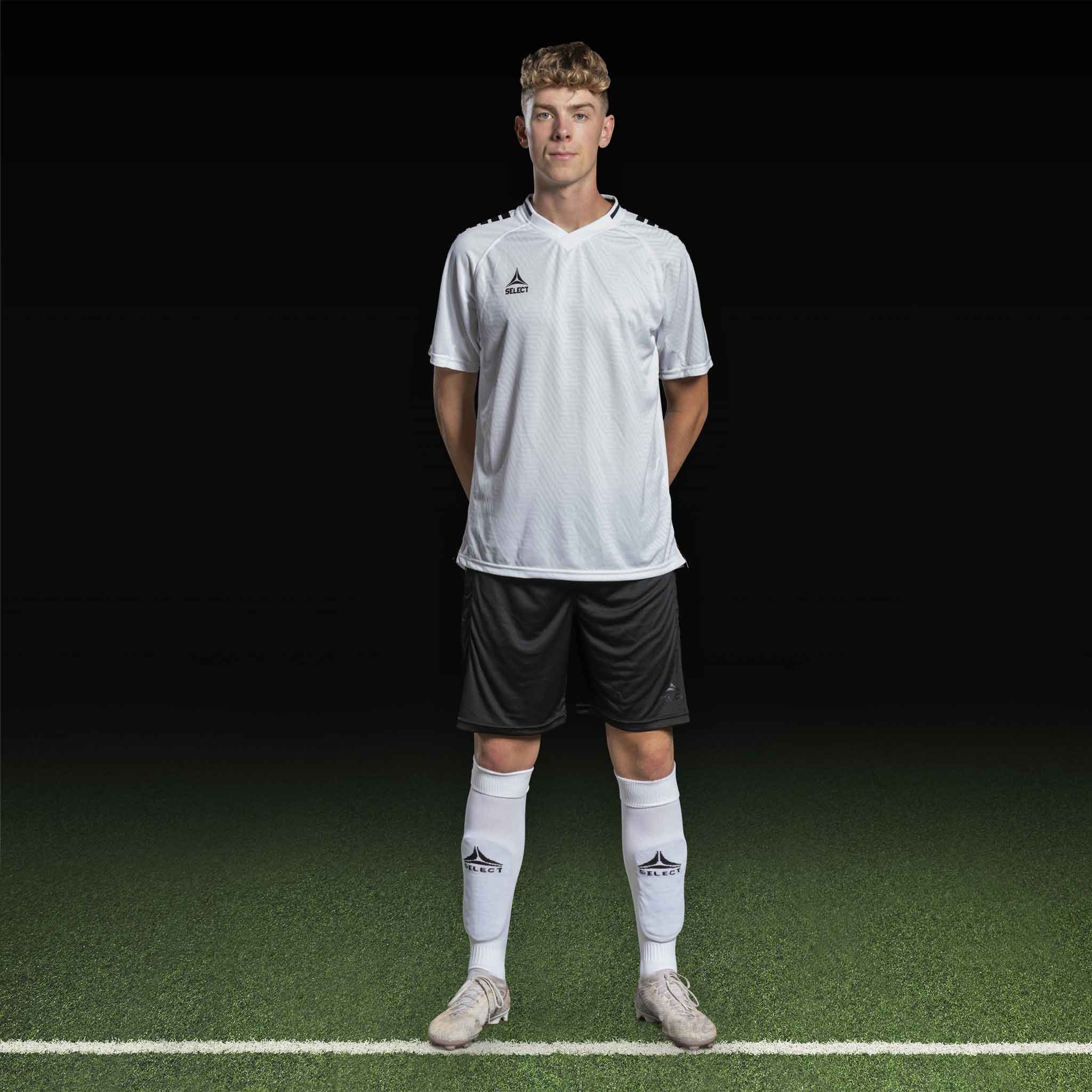 Mannlig fotballspiller i hvit Player shirt S/S Monaco v24 med sorte shorts, Match & Training wear, forfra.