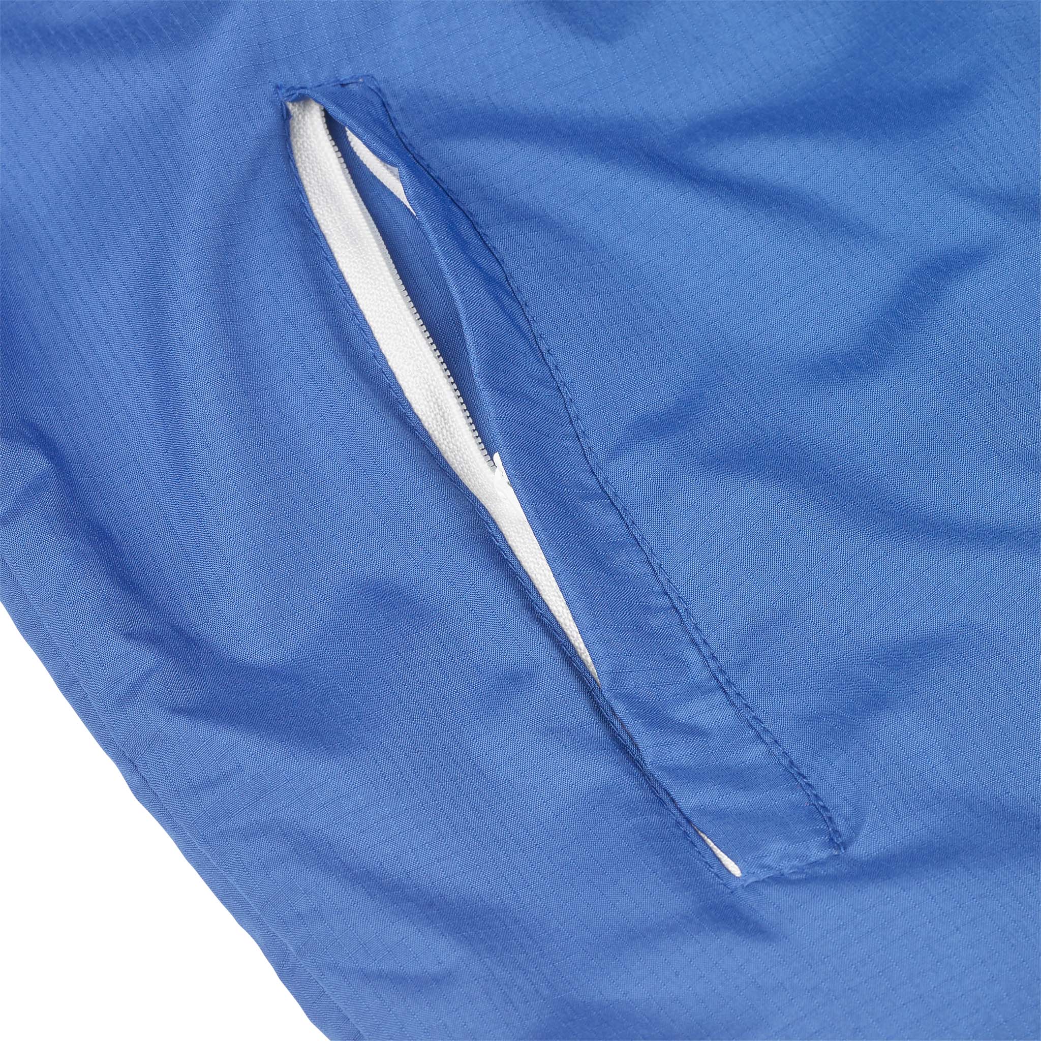 Nærbilde av blå Training jacket Spain v25, Match & Training wear, med hvit glidelåslomme