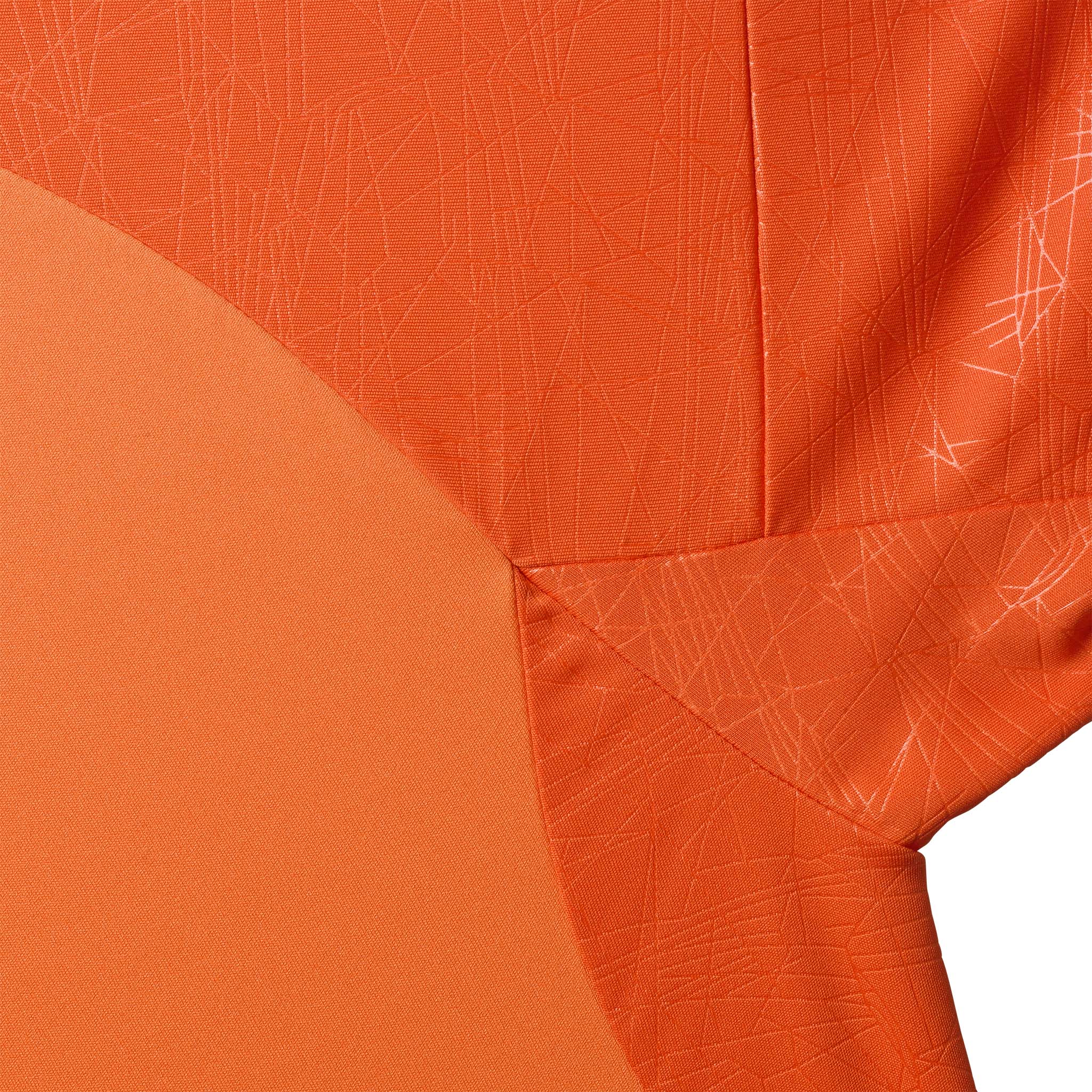 Nærbilde av Player shirt S/S Spain v25, Match & Training wear, i oransje med diskret strukturert mønster.